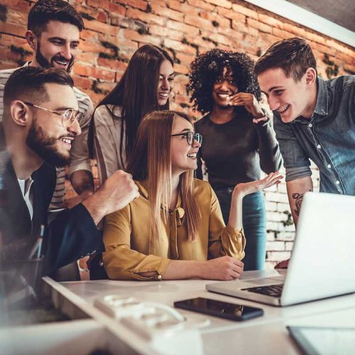 happy small business team reviewing health insurance plans